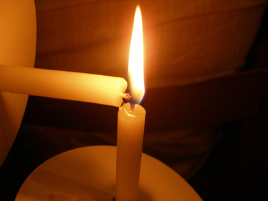 A candle is lighting another candle