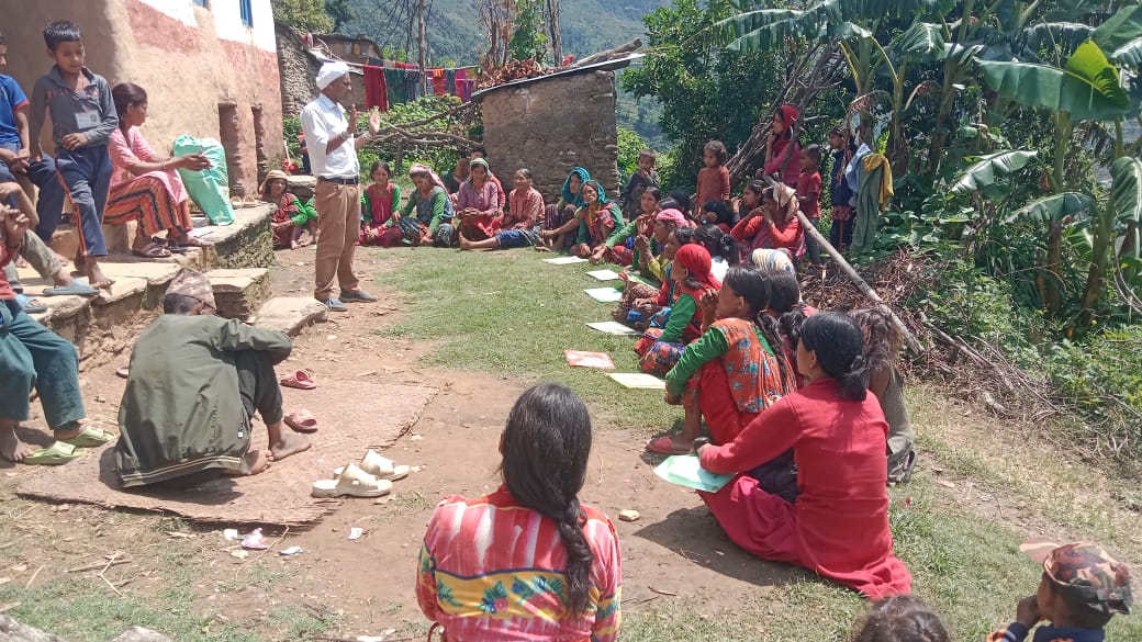 Dhami Tika Nepal conducting an awareness session on ending Harmful Traditional Practices (HTPs) in Purbichauki Rural Municipality–02, Baglek, Doti.